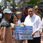 Plt. Sekda Leonard S. Ampung mewakili Gubernur Kalteng, H. Agustiar Sabran, menyerahkan BLT KHBS secara simbolis kepada masyarakat penerima manfaat. (foto : Ist)